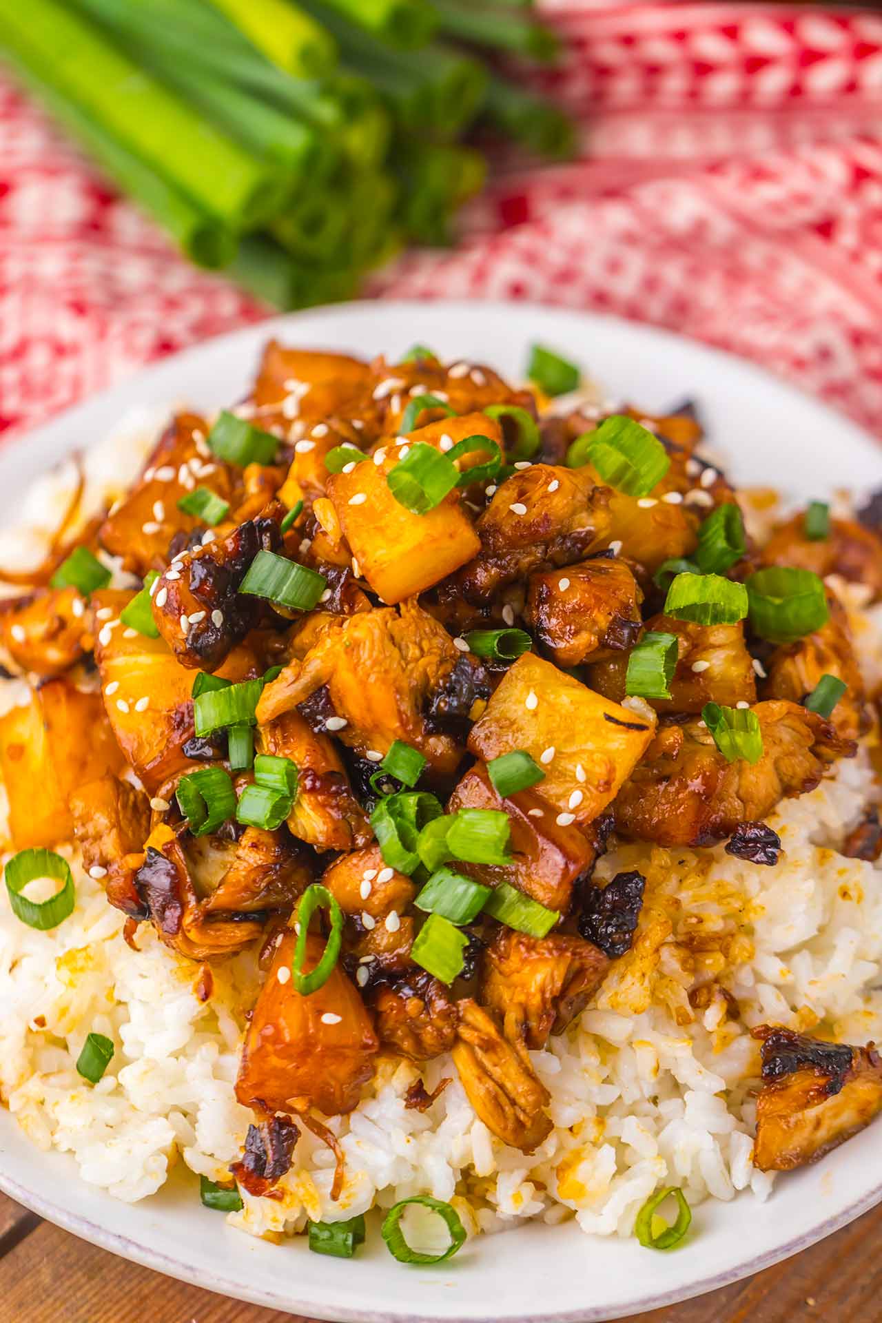 Closeup of a white bowl filled with Pineapple Chicken over rice.