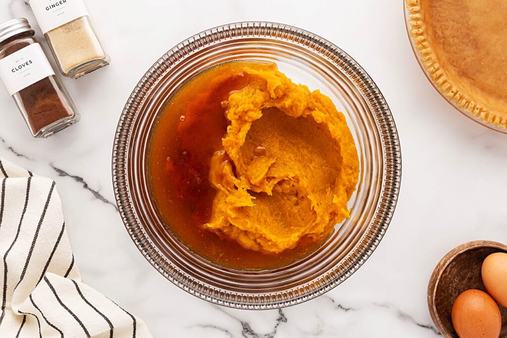 Honey added to pumpkin puree in a mixing bowl.