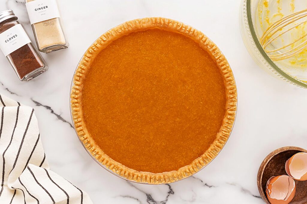 Pumpkin Pie batter poured into a crust.