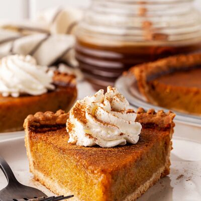 Front view of slice of pumpkin pie on a plate.