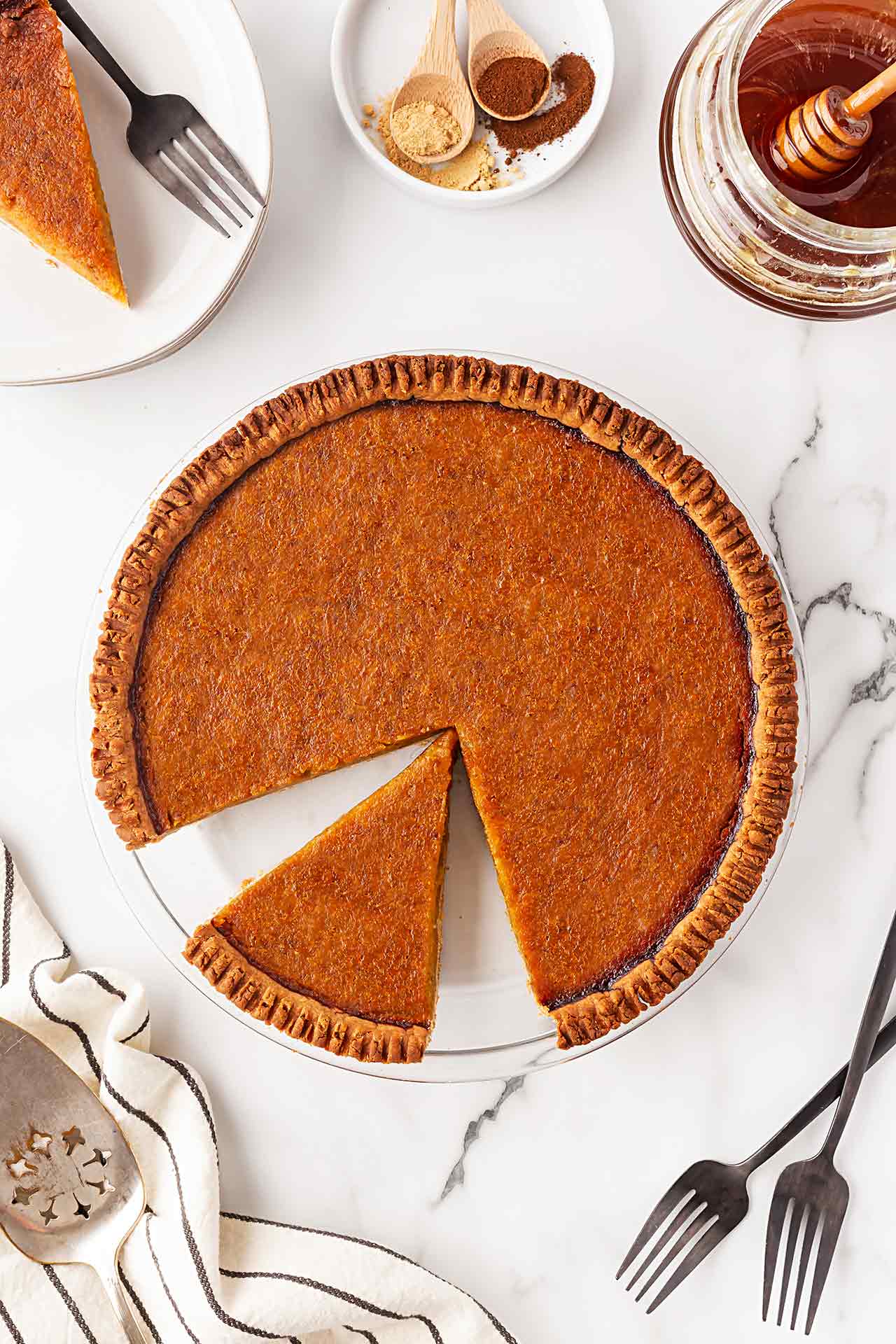 Overhead view of a Pumpkin Pie with a slice cut out.