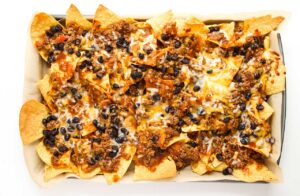 Melted cheese as a layer on Beef Enchilada Nachos.