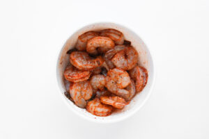 Seasoned shrimp in a mixing bowl.