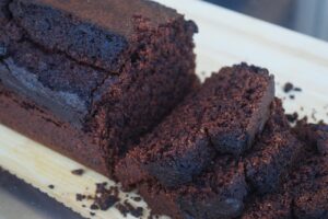 Horizontal side view of a partially sliced loaf of chocolate bread. Close up.