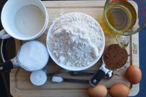 Chocolate bread ingredients collected on a wood cutting board.