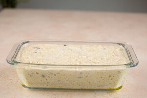 Oat bread batter in a loaf pan.