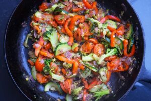 Sautéed vegetables in a cast iron skillet.