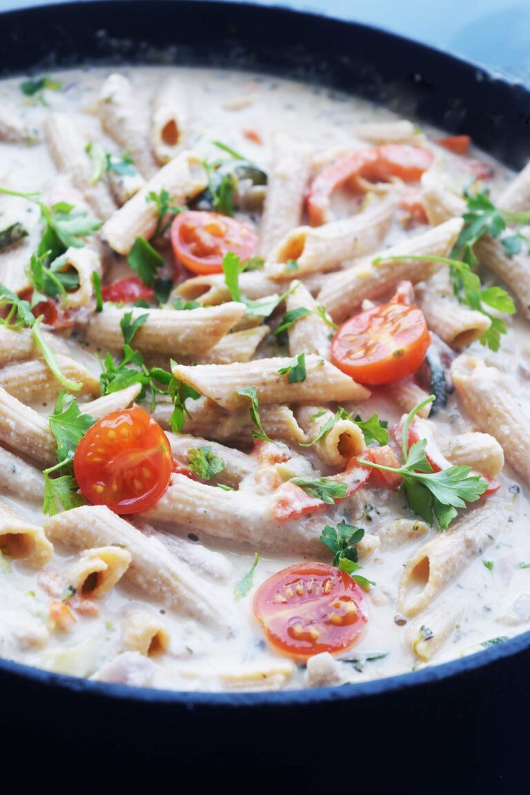 Front view of a cast iron skillet full of Pasta Primavera.