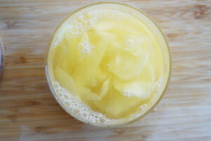 Ginger slices in brine in an open jar.