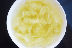 Ginger slices soaking in hot water.