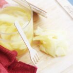 Overhead focus. Pickled ginger in a jar and on a cutting board the jar is sitting on.