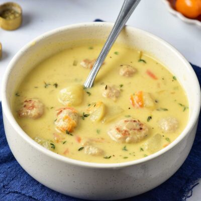 Front view of a white bowl filled with Turkey Meatball Soup.