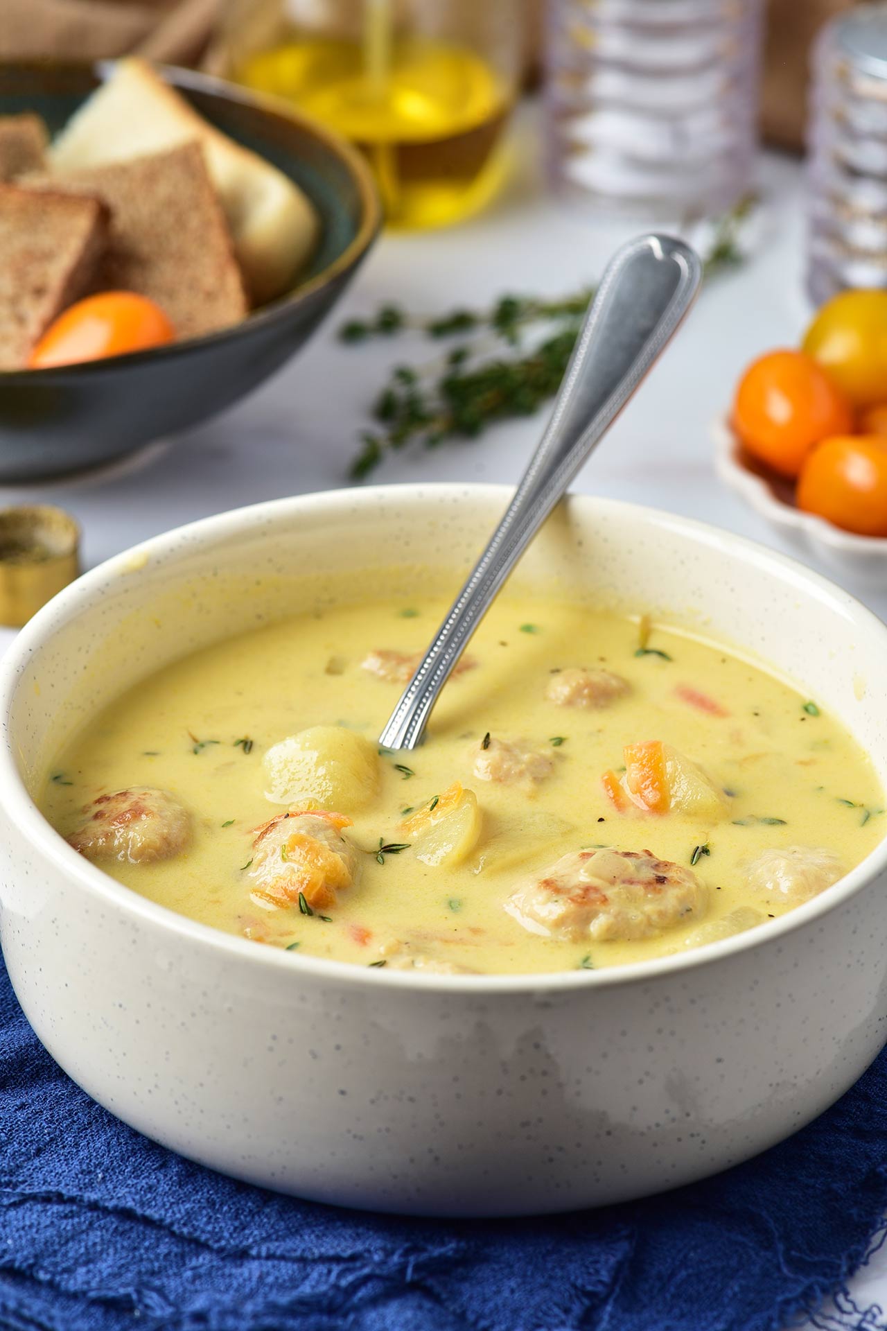 A white bowl filled with Turkey Meatball Soup.