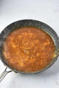 Gravy cooking in a skillet.