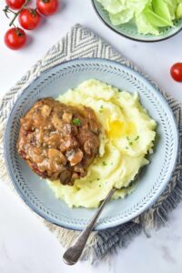 Turkey Salisbury Steak served over mashed potatoes. Overhead focus.