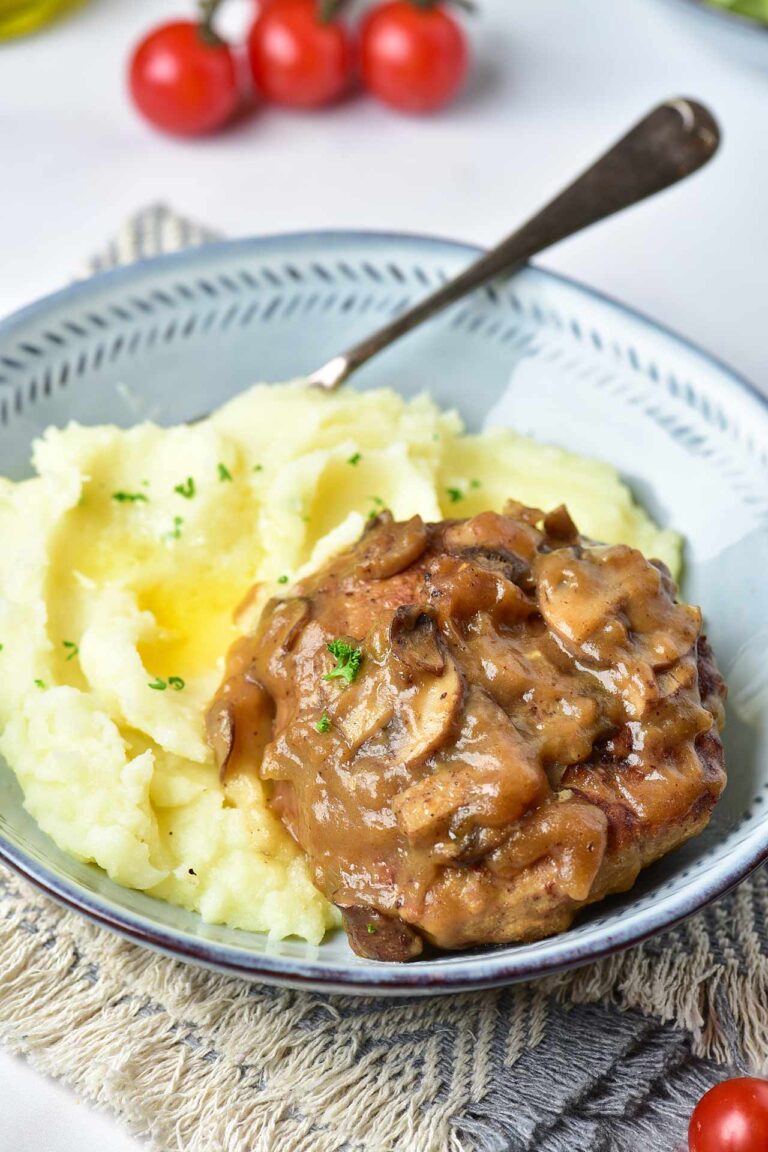 Front view of a Turkey Salisbury Steak over mashed potatoes.