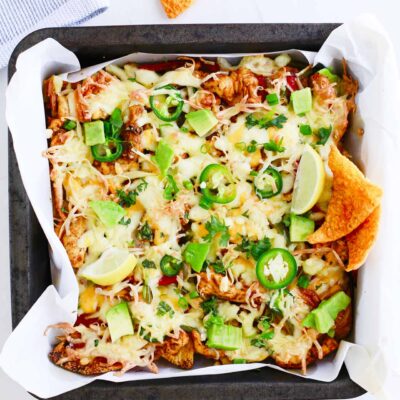 Overhead focus. Sheet pan full of Chicken Fajita Nachos.