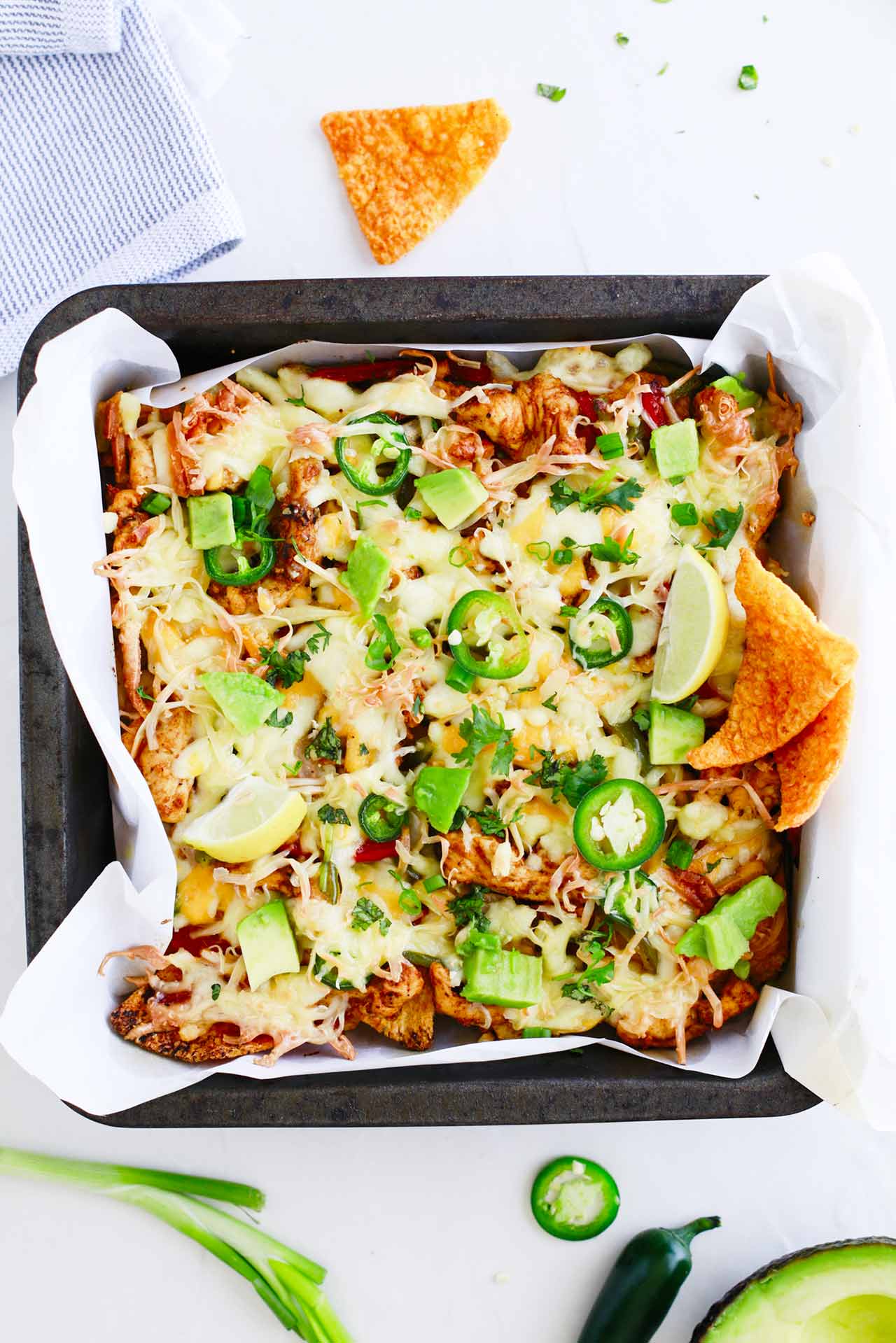 Overhead focus. Sheet pan full of Chicken Fajita Nachos.