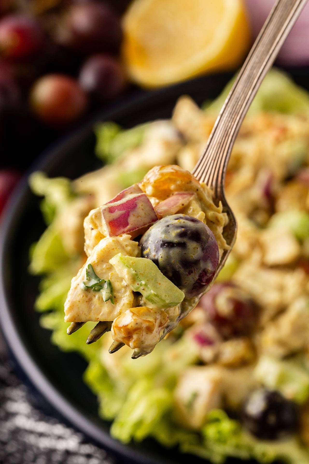 A fork holds a bit of curried chicken salad.