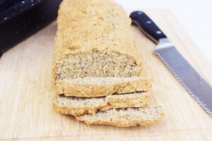 Front view of a partially sliced loaf of High-Protein Bread.