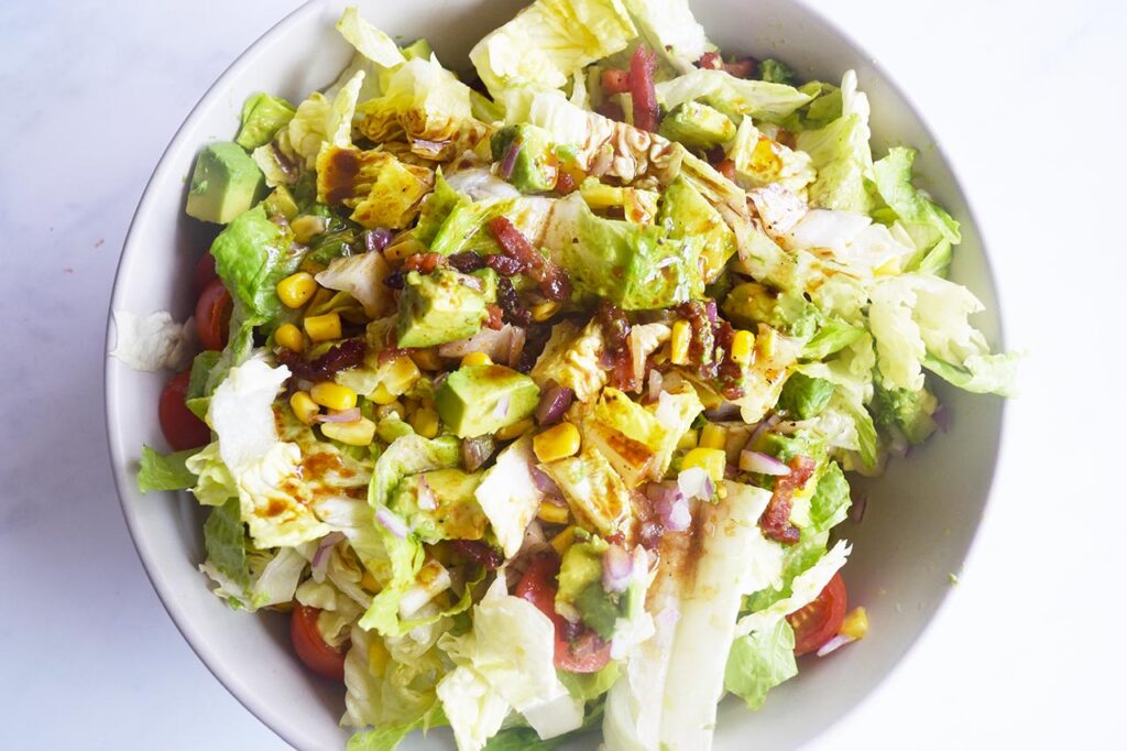 Overhead focus. Finished Loaded Bacon Salad with dressing.