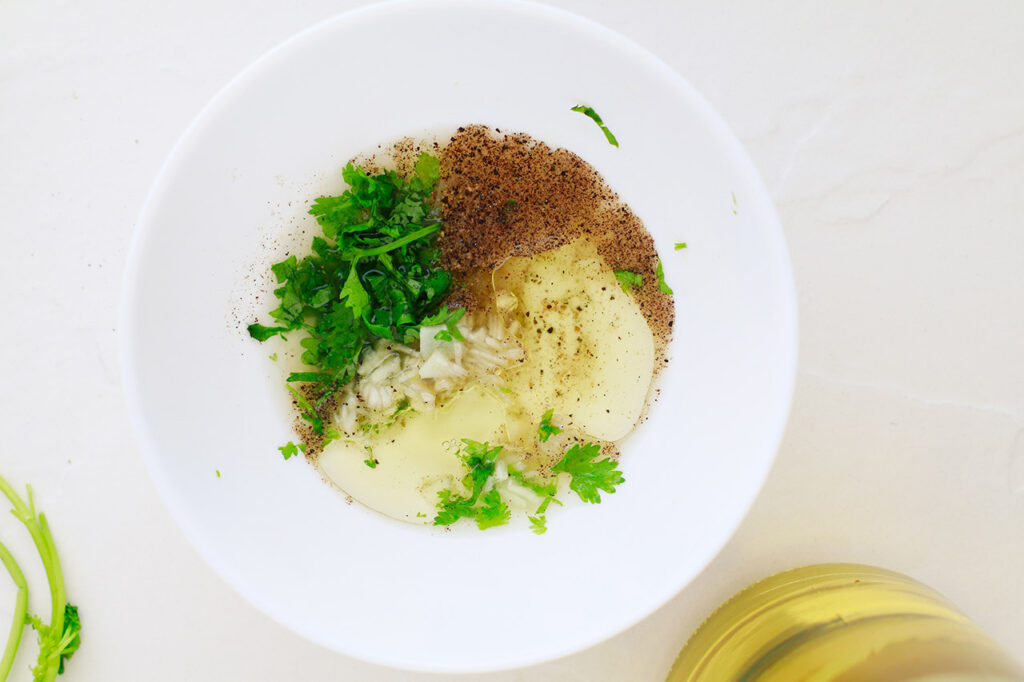 Dressing ingredients in white mixing bowl.
