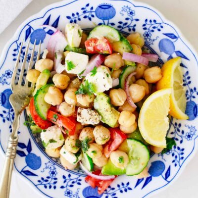 A Mediterranean Chickpea Salad in a decorative bowl. Overhead focus.