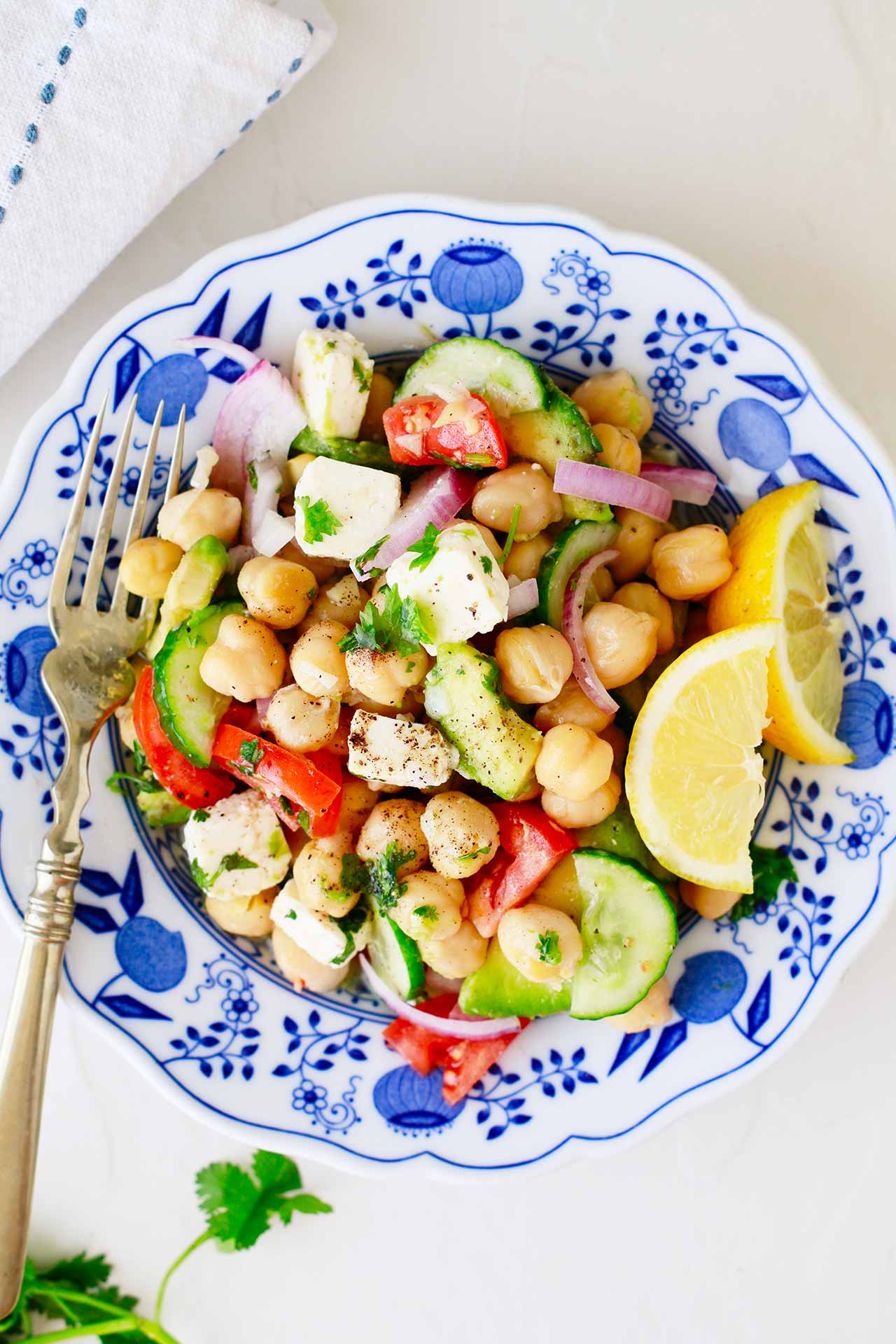 A Mediterranean Chickpea Salad in a decorative bowl. Overhead focus.