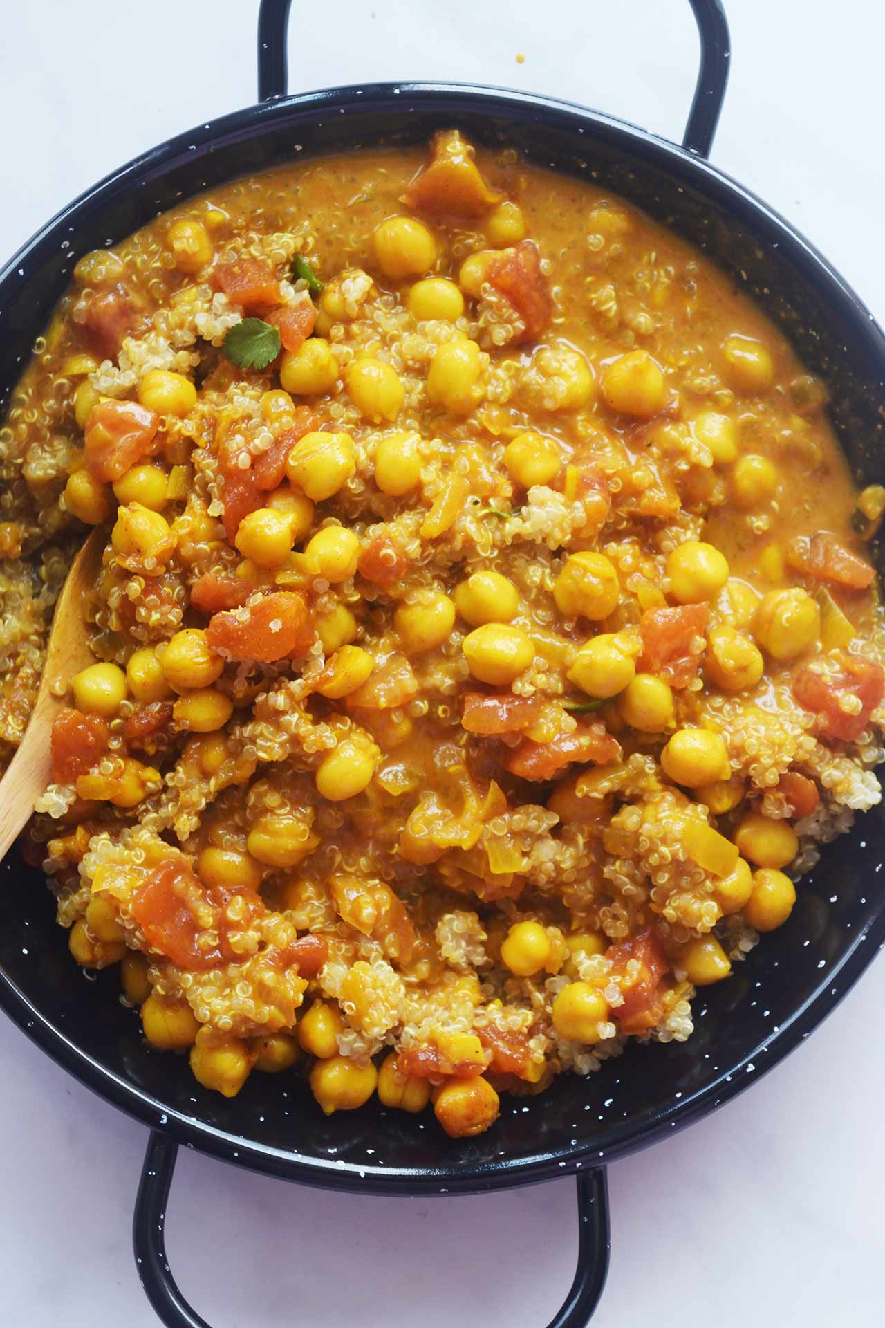 Overhead view of a pan filled with Moroccan Chickpea Stew mixed with quinoa.