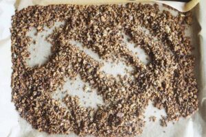 Toasted and stirred Pangrattato on parchment, cooling.