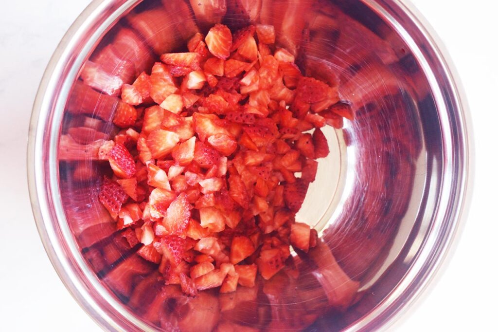 Chopped strawberries in a mixing bowl.