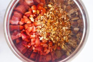 Chopped strawberries and chopped almonds in a mixing bowl.