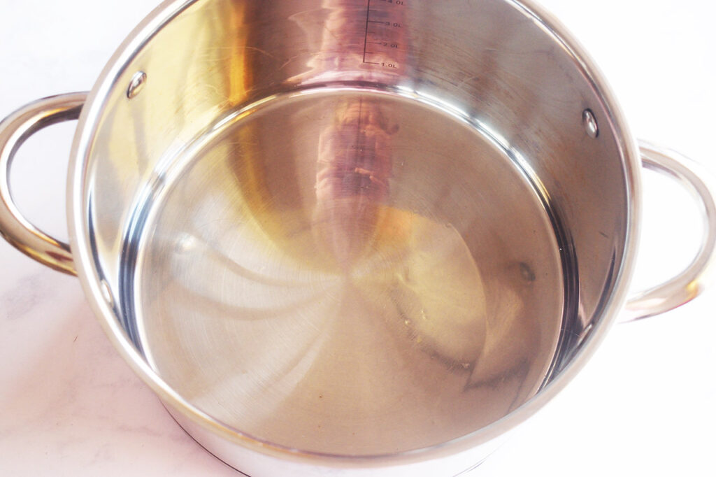 Oil heated in a pot.