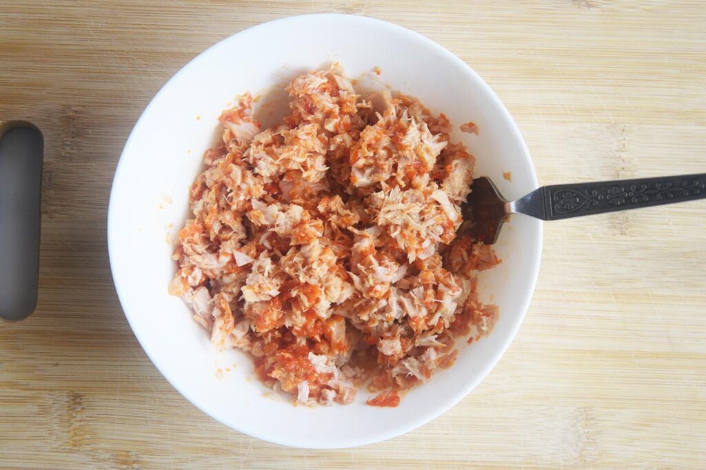 Sriracha tuna mixed in a white bowl.