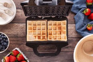 Cooked waffles on a waffle maker.