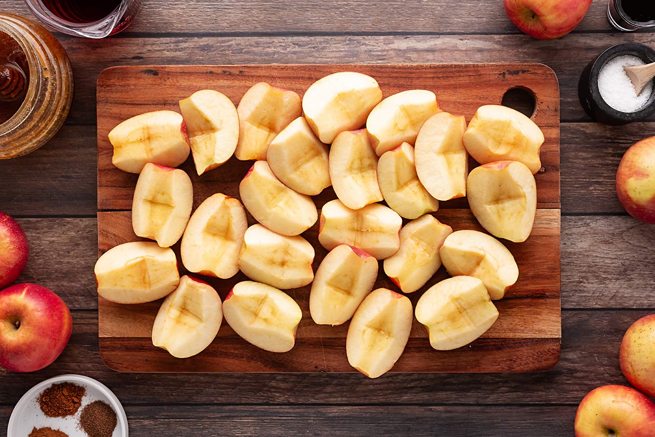 Cut apples on a cutting board. Overhead focus.