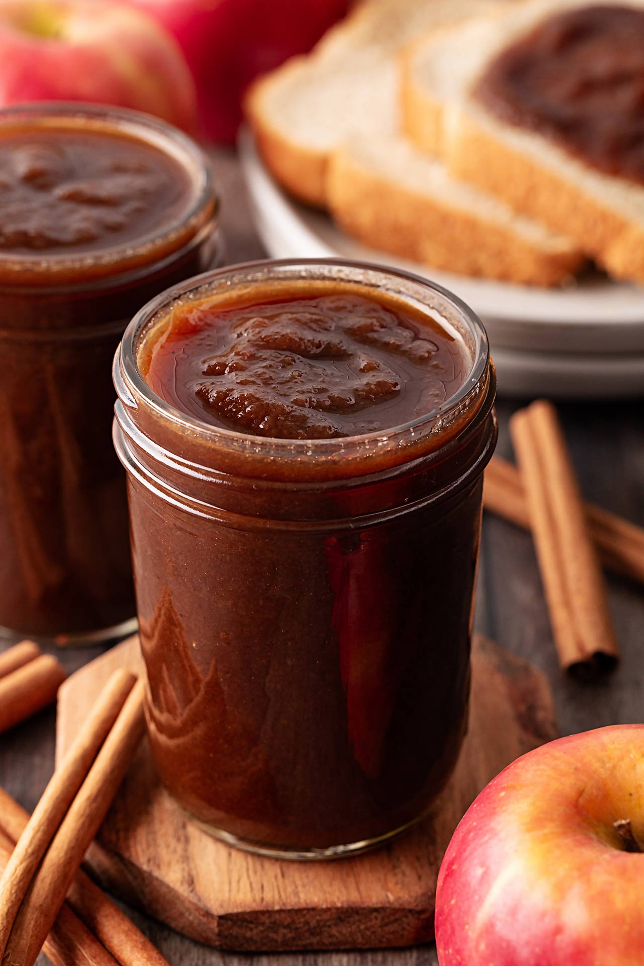 Two open jars filled with apple butter.
