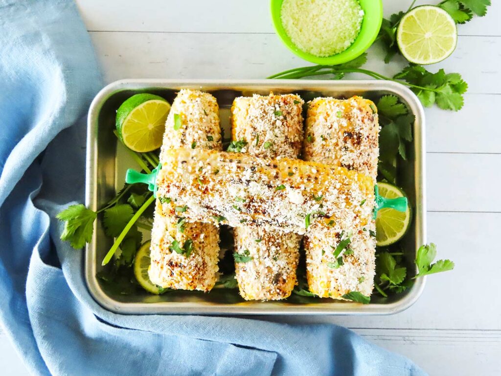 Overhead focus. Metal tray holding elotes.