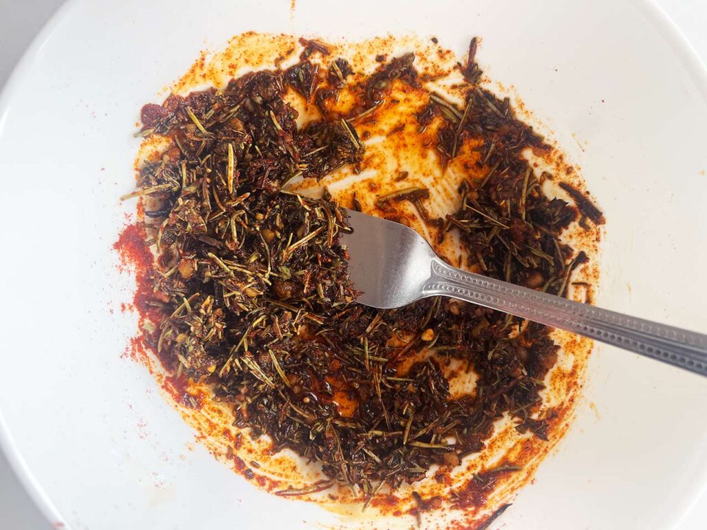 Chicken seasoning mixed in a white mixing bowl.