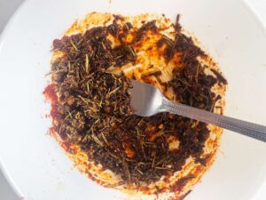 Chicken seasoning mixed in a white mixing bowl.