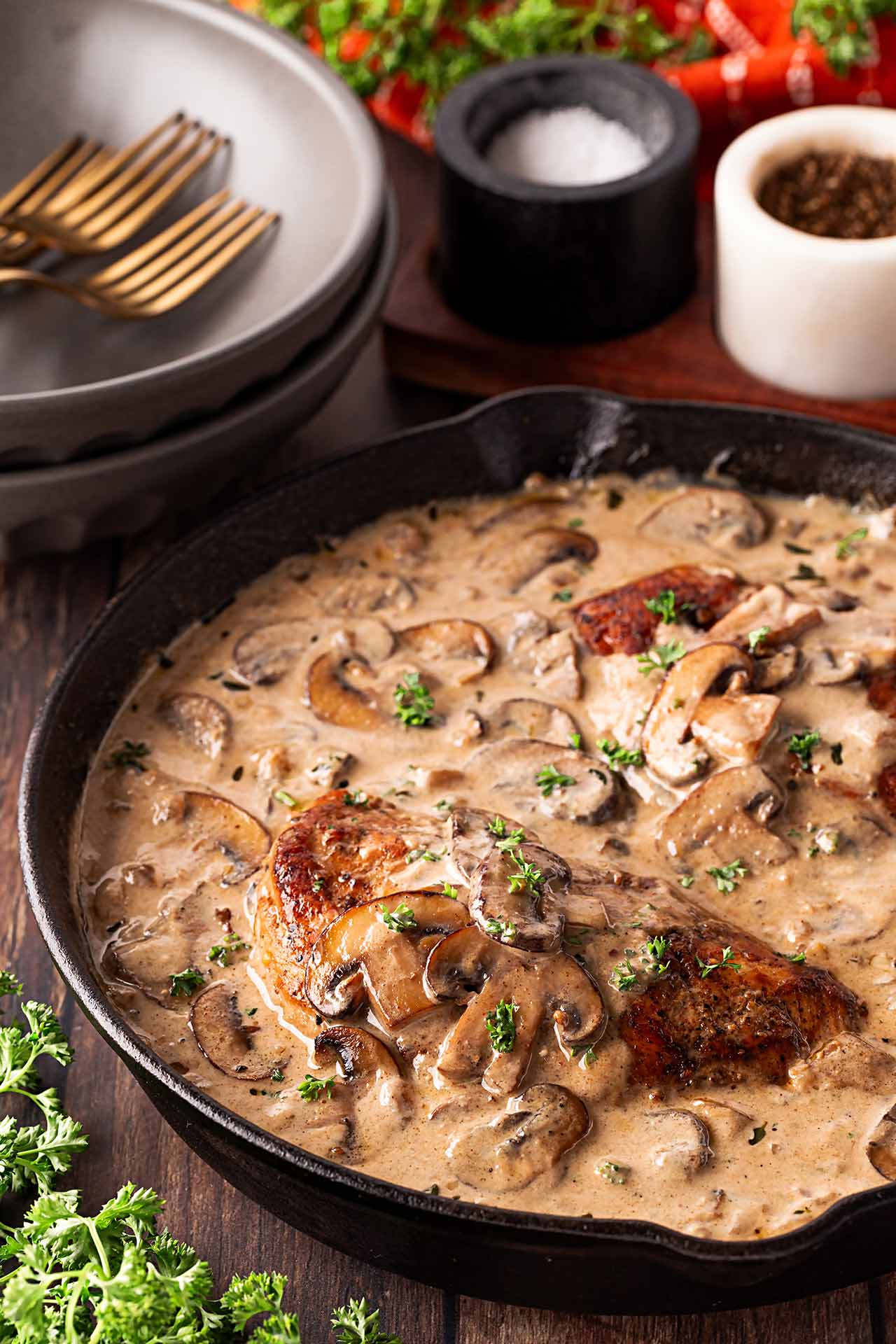 Front view of a black skillet filled with Creamy Mushroom Chicken.