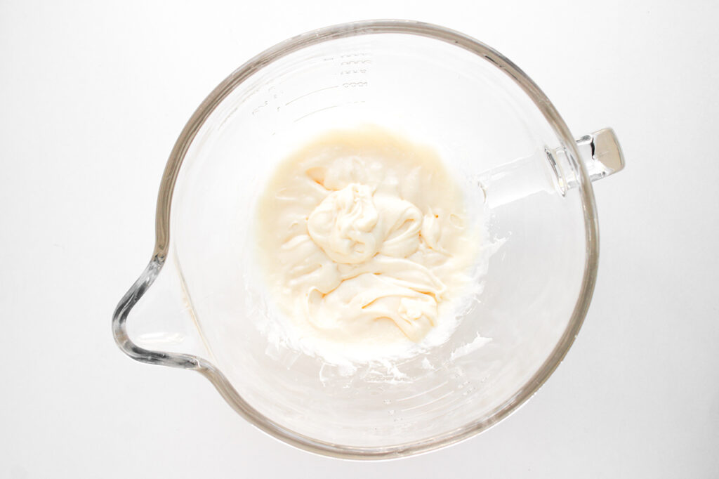 Blended cream cheese filling in a blender tumbler.