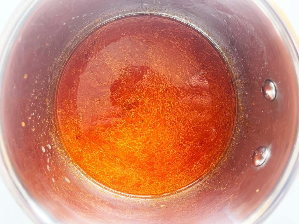 Bravas sauce ingredients added to a pot.
