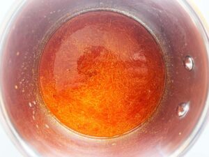 Bravas sauce ingredients added to a pot.
