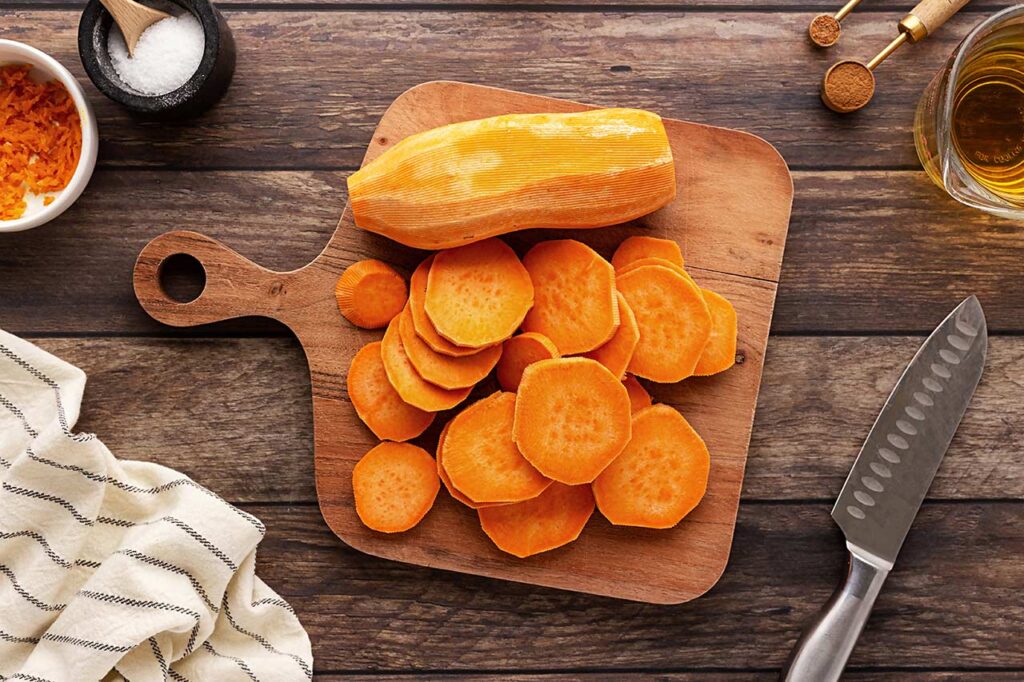 Sliced sweet potato on a cutting board.