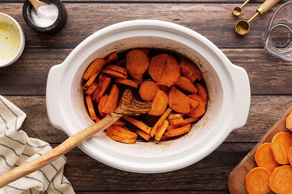 Raw Sweet Potato Butter ingredient stirred together in a slow cooker crock.