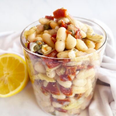 Tuscan White Bean Salad in an open glass jar.
