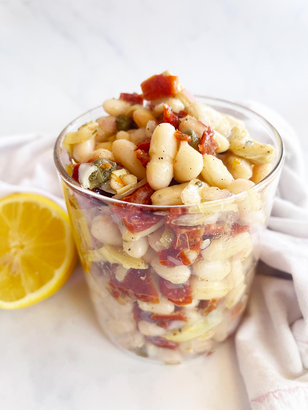 Tuscan White Bean Salad in an open glass jar.