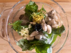Artichoke Pesto ingredients in a food processor, unblended.