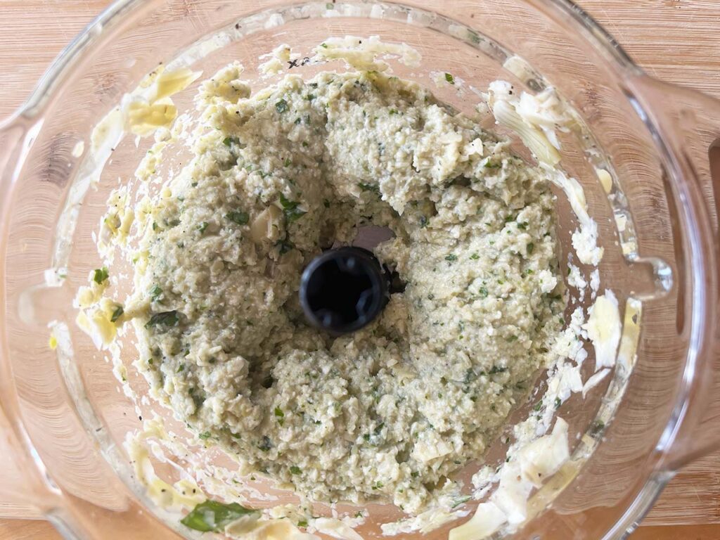 Artichoke Pesto ingredients, blended in a food processor. Overhead focus.